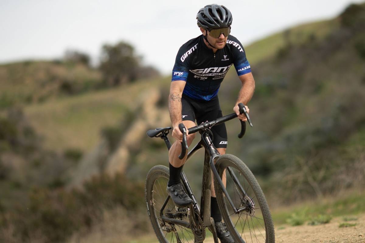 Cyclist wearing Giant cycling gear and accessories riding a Giant bicycle on a scenic rout